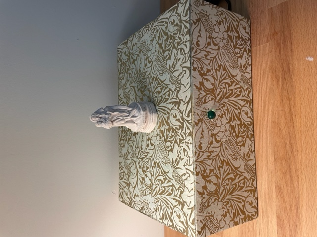 Photo showing a figurine atop the box museum